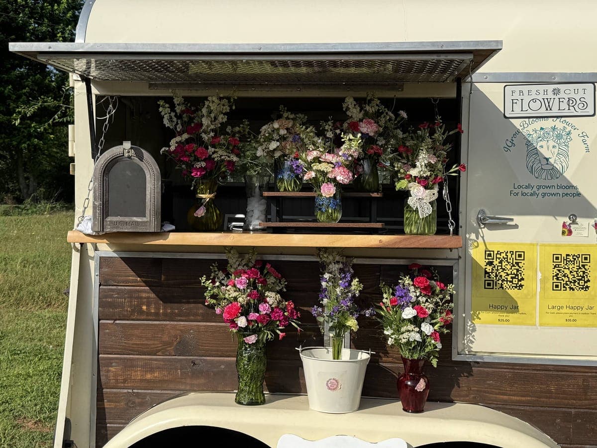 Front view of trailer in self-serve mode with mason jars, vintage mailbox, and QR pricing